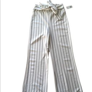 Brand New With Tags: Stretch White and Black Striped Pants w/ Tie Detail. Size M